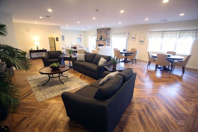 Spacious community lounge with herringbone floors