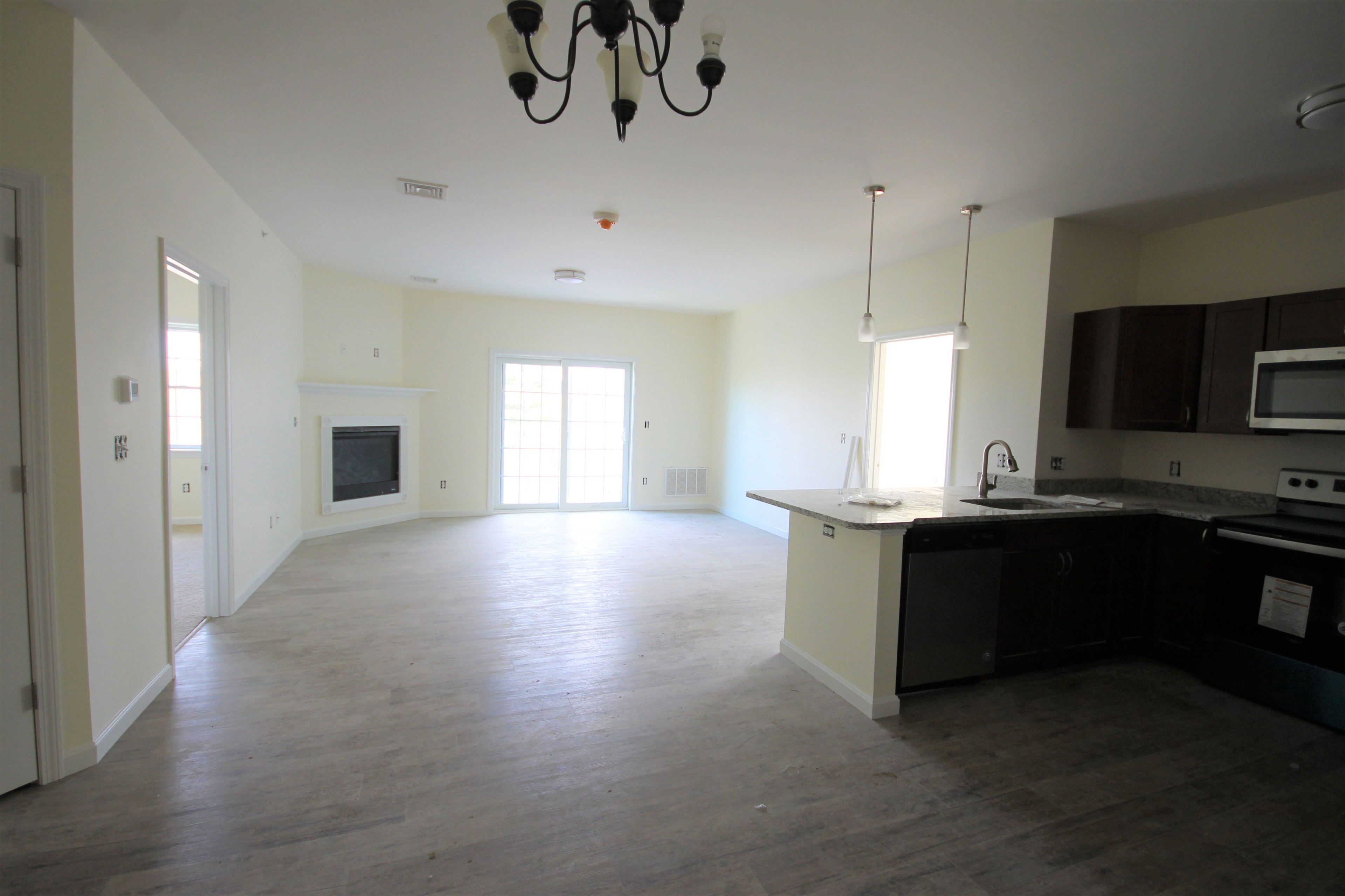 Open living and kitchen with fireplace and hardwood floors